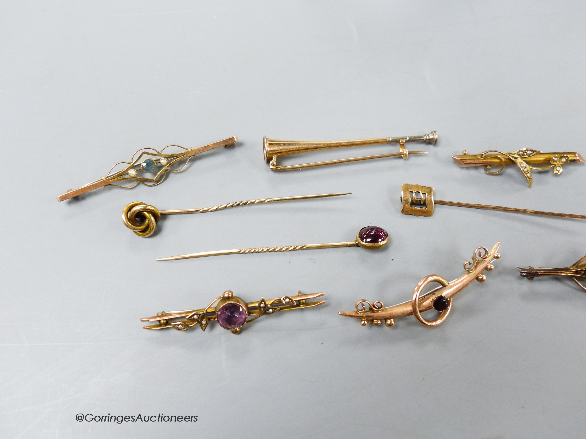 Four assorted early 20th century 9ct and gem set bar brooches, gross 9.1 grams, two yellow metal bar brooches including hunting horn and two yellow metal gem set stick pins, gross 10 grams and a 15ct stick pin, 1.4 grams